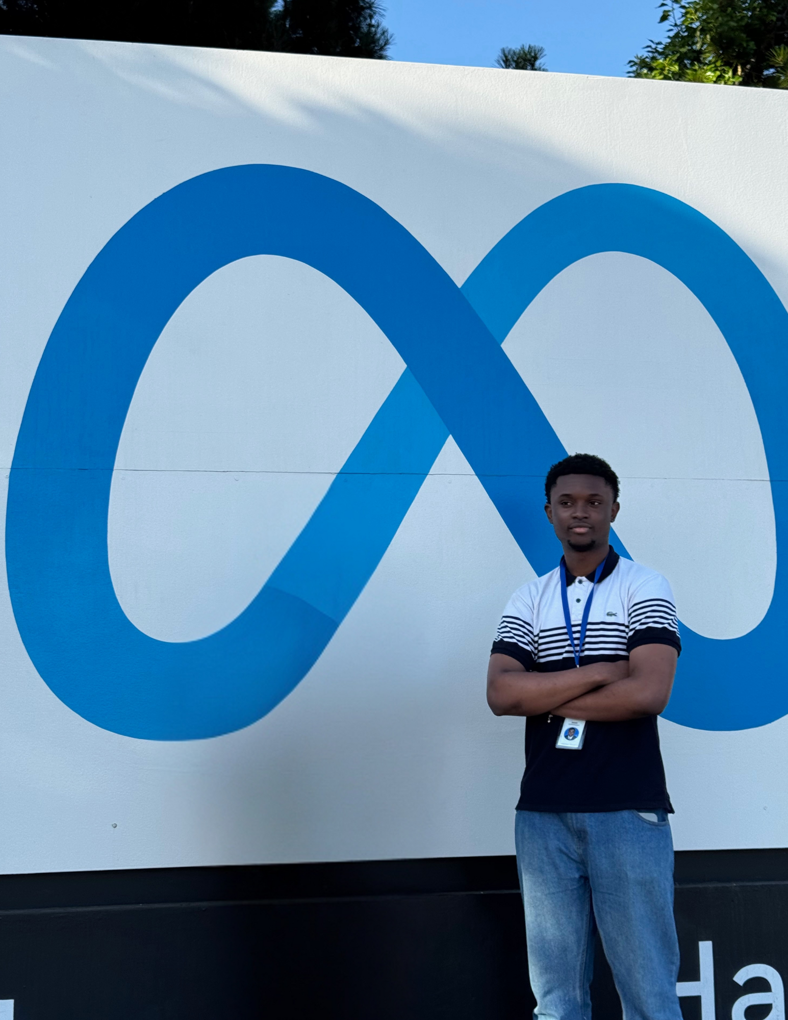 Image of Jason Chimdinma Jason by Meta's Monument sign in Menlo Park Office